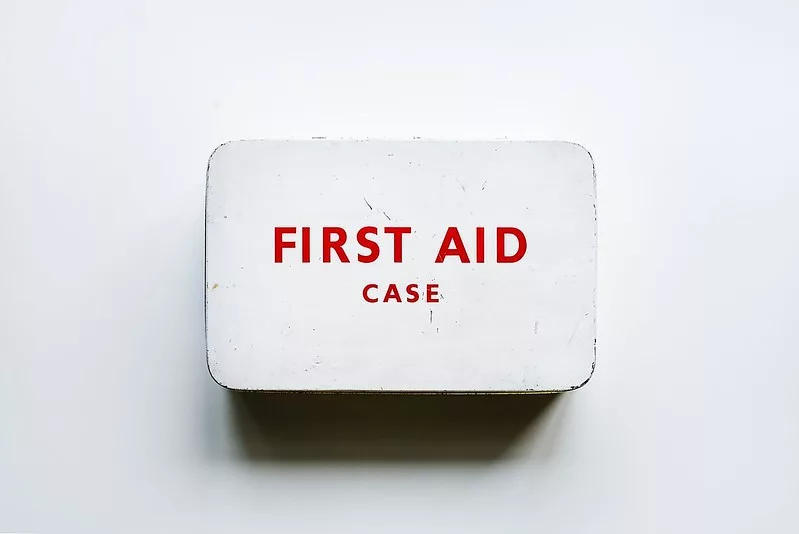 white metal box with "first aid case" written on it