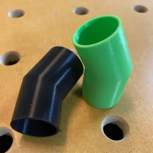 Two plastic, conical-shaped adapters to connect a Festool Track Saw to the dust collection hose