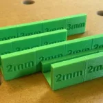 Many plastic drawer spacers between sitting on a woodworking bench