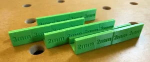 Many plastic drawer spacers between sitting on a woodworking bench