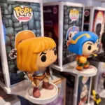 Funko Pop wall mount holding a He-Man Funko Pop figure and it's box